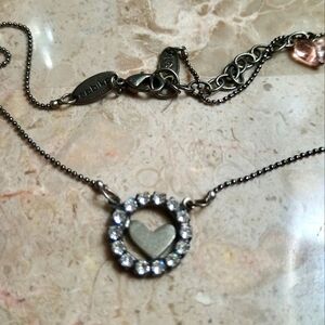 Elegant Silver Necklace with Heart Pendant and rhinestones.